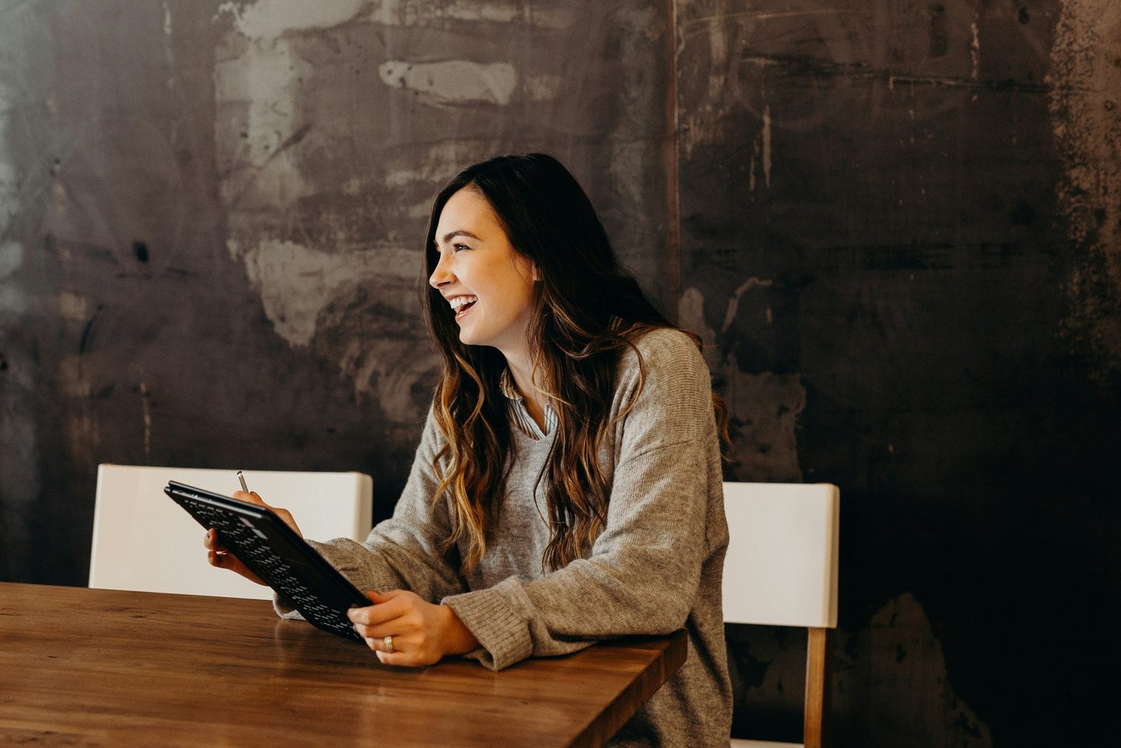 woman sitting around table - Astrologer Abhishek Soni woman sitting around table holding tablet